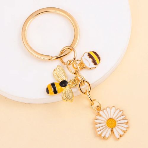 variante avec une abeille, une marguerite et du miel du Porte Clé Abeille